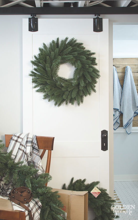 Rustic Christmas decor with gorgeous wreath on sliding barn style door