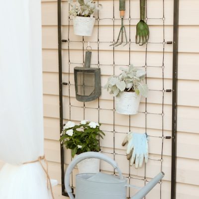 Repurposed crib garden tool hanger